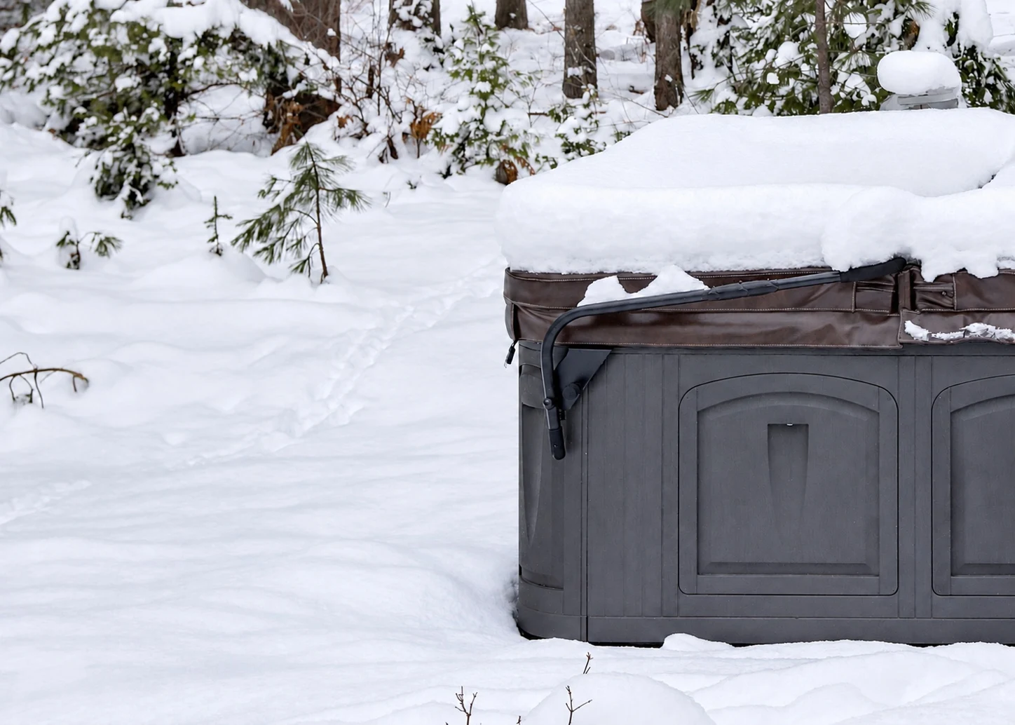 Covered outdoor hot tub surrounded by deep snow